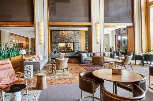a lobby with tables and chairs and a fireplace at Westin #215 A- 1 Bedroom in Avon