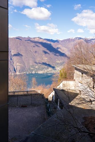a view of a lake and mountains from a building at Hotel Funicolare in Lanzo dʼIntelvi
