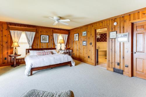 a bedroom with wooden walls and a bed and a ceiling at Private Dock at Lake George Getaway in Lake George