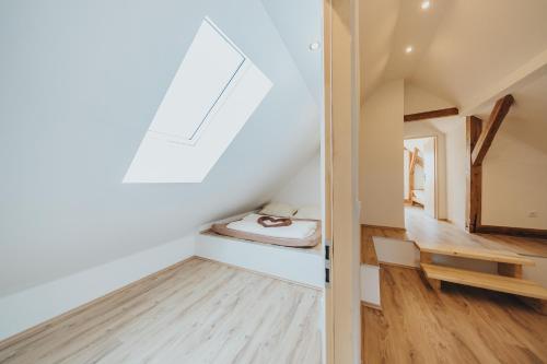 a small attic room with a bed and a skylight at Chalupa Ve Stráních Deštná in Jindrichuv Hradec