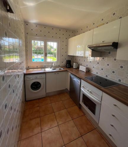 a kitchen with a sink and a washing machine at Marbella Villas in Marbella