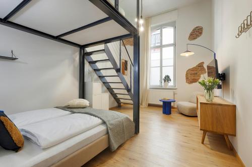 a bedroom with a bed and a staircase at homie stay am spital in Würzburg