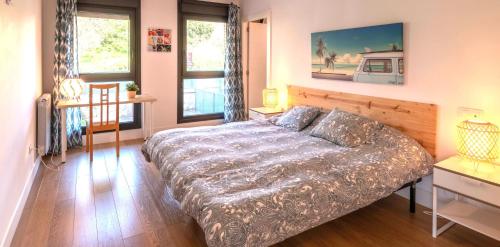 a bedroom with a bed and a couch in it at Laga Blue Surf in Ibarrangelu