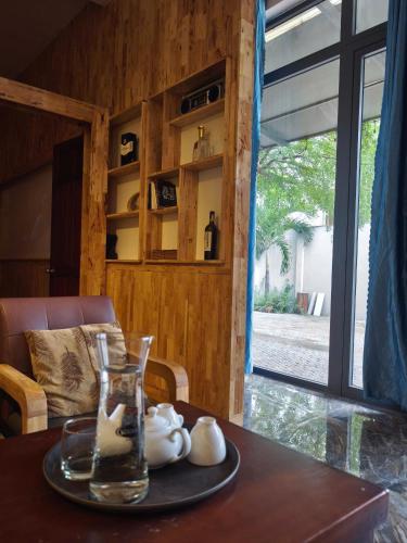a table with a glass vase on top of it at Long Homestay Mỹ Hạnh - Hotels in Ðức Hòa
