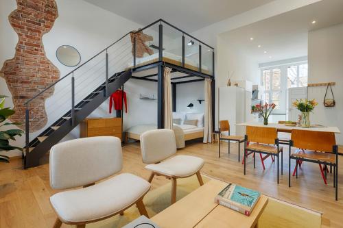a living room with a staircase and a dining room at homie stay am spital in Würzburg
