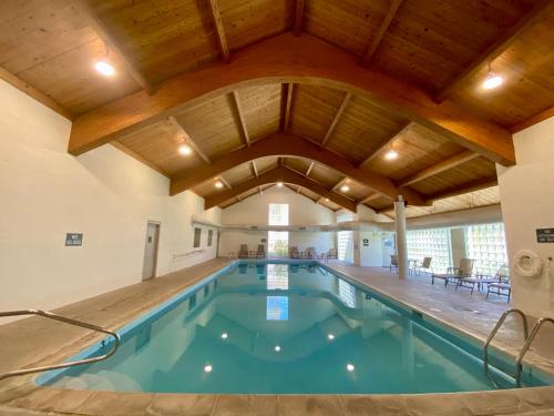 an indoor swimming pool with a large wooden ceiling at Quicksilver 1613 by SummitCove Lodging in Keystone