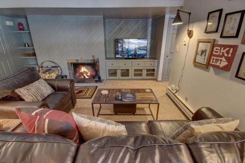 a living room with a couch and a fireplace at Wild Irishman 1059 by SummitCove Lodging in Colorado in Keystone