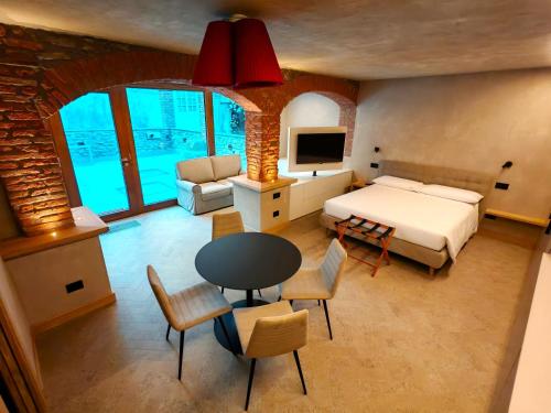 a bedroom with a bed and a table and chairs at Le Reve Charmant Apartments - Via De L ostan, 18 in Aosta