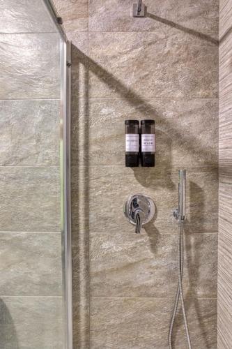 a shower with a glass door with two bottles at Luxury Apartment in St Pauls Bay w pool by Homely in St. Paul's Bay