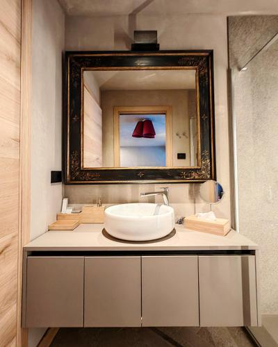 a bathroom with a sink and a mirror at Le Reve Charmant Apartments - Via De L ostan, 18 in Aosta