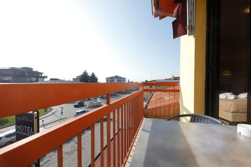 a balcony of a building with a view of a street at Hotel Primavera in Peschiera del Garda