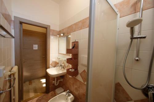 a bathroom with a sink and a toilet and a shower at Hotel Primavera in Peschiera del Garda