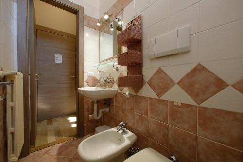 a bathroom with a sink and a toilet at Hotel Primavera in Peschiera del Garda