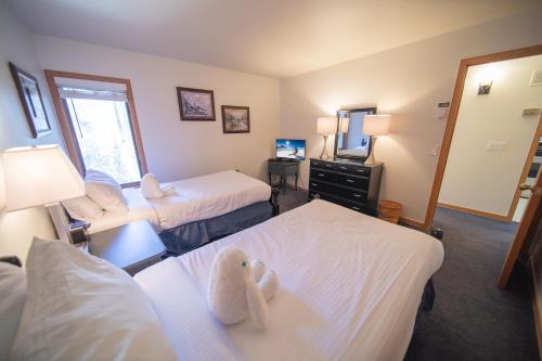 a hotel room with two beds and a television at Ski Run 202 by SummitCove Lodging in Keystone