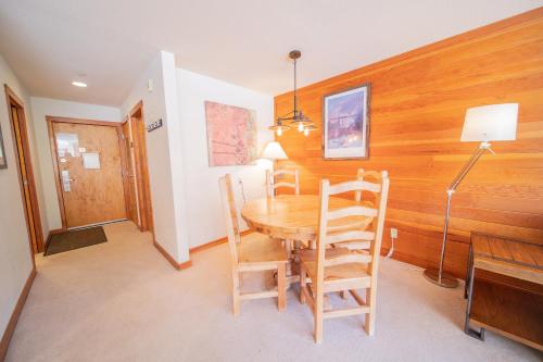 a dining room with a wooden table and chairs at Lakeside 1495 by SummitCove Lodging in Keystone