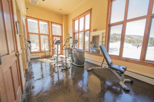 a gym with exercise equipment in a room with windows at Red Hawk Lodge 2297 by SummitCove Lodging in Keystone