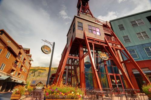a building with tables and chairs in front of it at Red Hawk Lodge 2297 by SummitCove Lodging in Keystone
