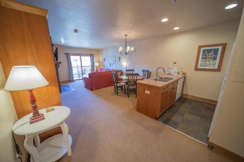 a kitchen and living room with a table and a couch at Red Hawk Lodge 2297 by SummitCove Lodging in Keystone