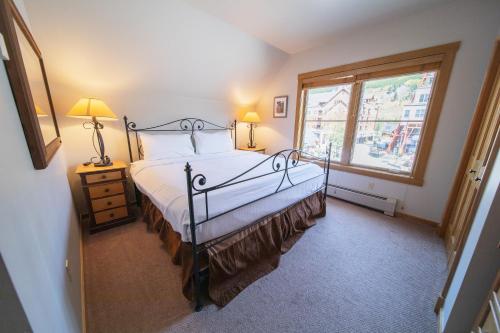 ein Schlafzimmer mit einem Bett und einem großen Fenster in der Unterkunft Black Bear 8064 by SummitCove Lodging in Keystone