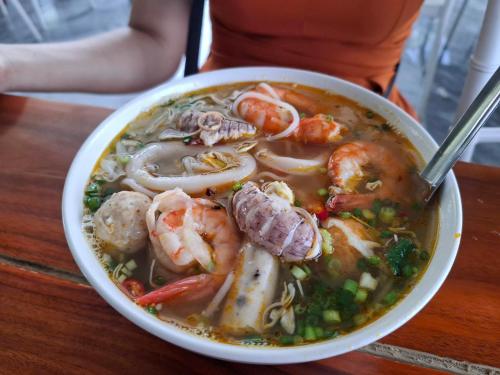 a bowl of seafood soup with shrimp and sausage at Flamingo1 Ibiza Hai Tien in Nam Khê