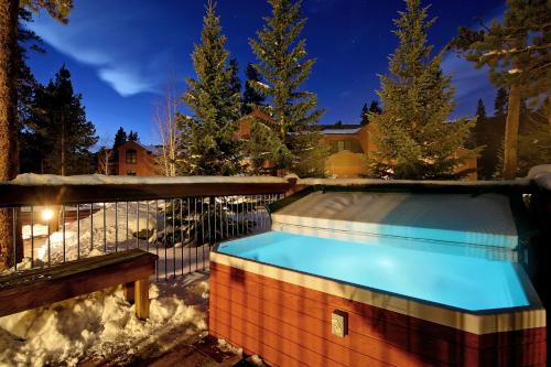 a hot tub in a backyard in the snow at Starfire 1992 by SummitCove Lodging in Keystone