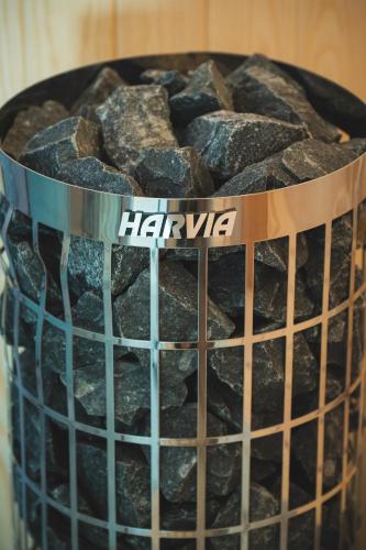 a metal bowl of rocks with a sign on it at Minimalist Mediterranean Blue key Villa with Sea View & Infinity Heated Pool in Agia Pelagia
