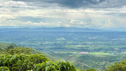 a view of a valley from the top of a mountain at La Font Ecolodge in Buenavista