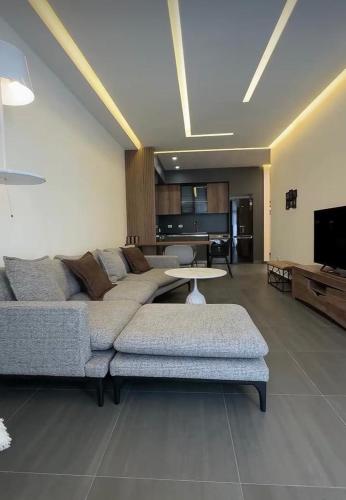 a living room with a couch and a table at Modern Well Renovated apartment in The heart of City Center , Open Balcony by Republic Square in Yerevan