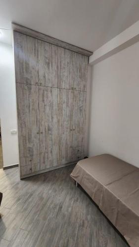 a bedroom with a large wooden wall next to a bed at Modern Well Renovated apartment in The heart of City Center , Open Balcony by Republic Square in Yerevan