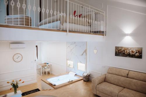 a living room with a couch and a staircase at Camilla Luxury Home in Nemi