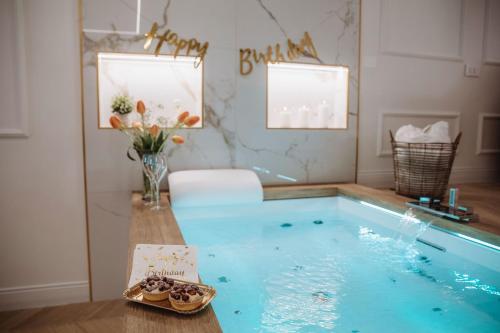a room with a swimming pool with a vase of flowers at Camilla Luxury Home in Nemi