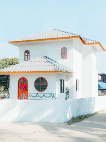 a white house with a red door at Private House near Airport Padaet in Chiang Mai
