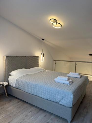 a bedroom with a bed with two towels on it at RoomElioti Apartments in Ofrínion