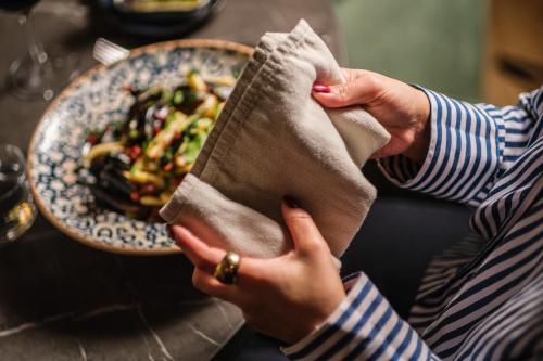 a woman holding a napkin with a bowl of food at Hyatt Place Gothenburg Central in Gothenburg