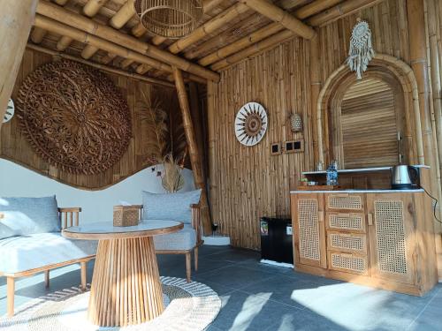 a room with a table and chairs and a kitchen at JinengBali Eco Lodge in Tegalalang
