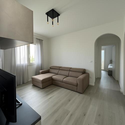 a living room with a couch and a television at AR Palace Hotel - Palermo in Isola delle Femmine