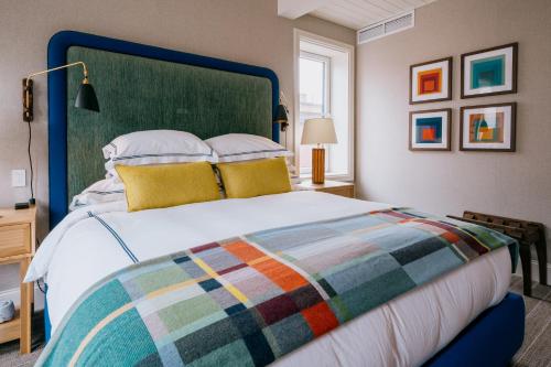 a bedroom with a large bed with a colorful blanket at Eleven Revelstoke Lodge in Revelstoke