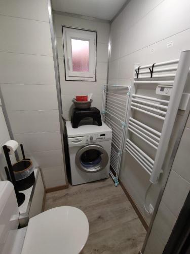 une petite salle de bains avec un lave-linge. dans l'établissement ThiLuCha Le ThiLu ALPE D'HUEZ gd domaine à Allemont, à Allemont