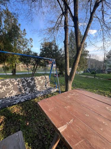 a park with a swing and a wooden table at Kutak Sreće in Vrdnik