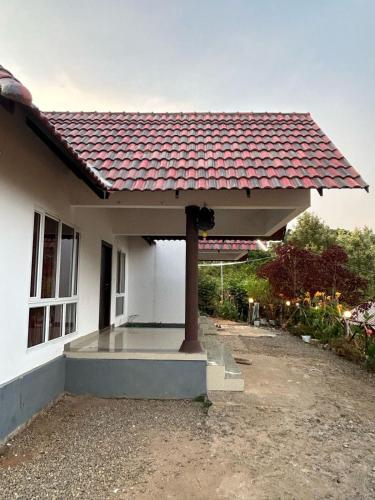 a house with a red tile roof on it at Kashmir Valley Alpha in Kanthalloor