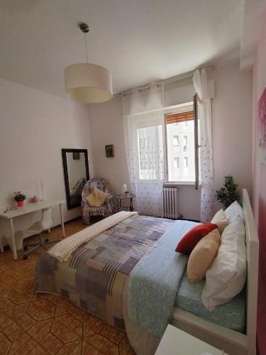 a bedroom with a large bed with pillows on it at Vicino alla stazione, un parcheggio e wifi in Ancona