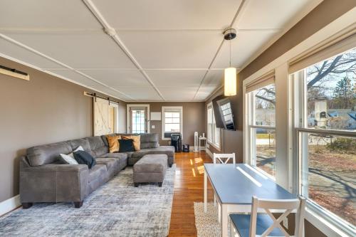 a living room with a couch and a table at 2 Mi to Colby College Peaceful Home in Waterville in Waterville