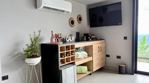 a kitchen with a black and wooden cabinet at La Font Ecolodge in Buenavista