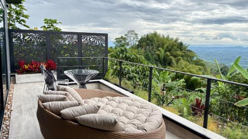 a balcony with a couch and a view of the ocean at La Font Ecolodge in Buenavista