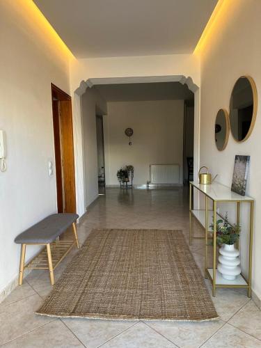 a living room with a table and a rug at Villa Isidora Luxe in Kalívia Thorikoú