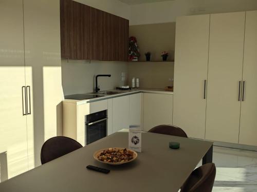 a kitchen with a table with a bowl of food on it at Penthouse in Afragola