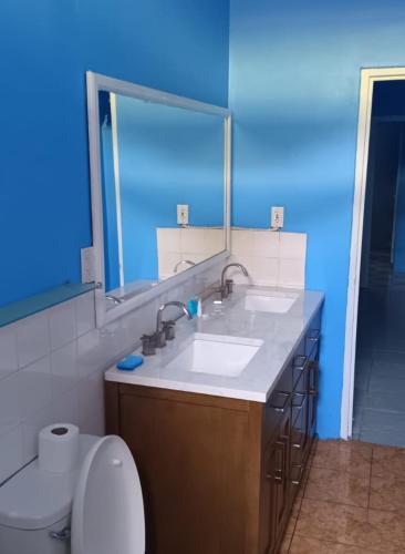 a bathroom with a white sink and a toilet at Michael's Beach Complex #3 in Brighton Village
