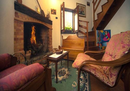 a living room with a fireplace and a piano at I Tre Tigli - Casa di campagna in Rutino