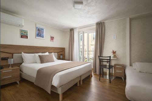 a hotel room with a large bed and a chair at Hotel des Congrès et Festivals in Cannes