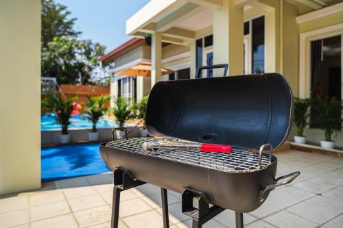 a grill with a pan on top of it at Luxury Massarossa Pool Villa Pattaya-21 in Pattaya Central